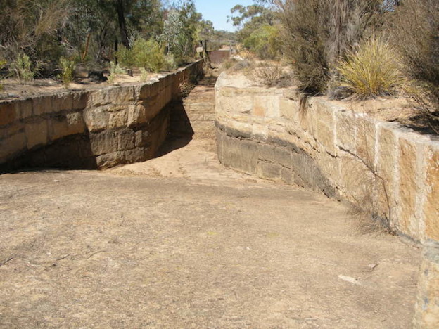 Diverting water from the rock to the aquaduct.